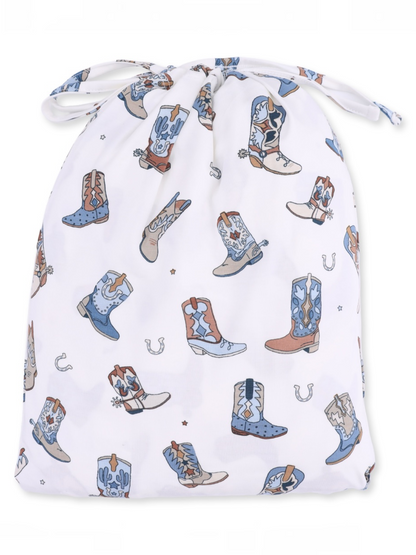 Drawstring bag with a whimsical pattern of cowboy boots and cacti on a white background.