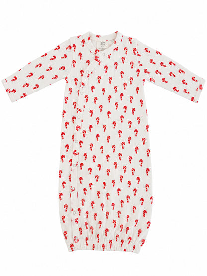 White baby gown with red candy cane print and snap buttons, ideal for seasonal wear.