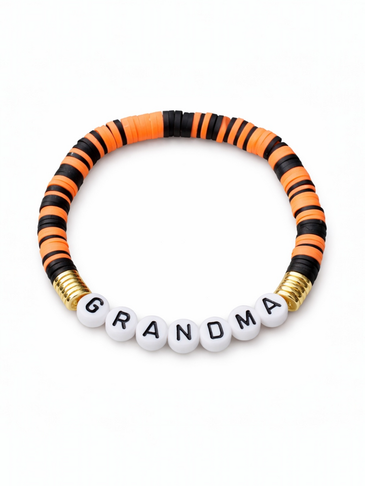 Colorful beaded bracelet with the word "GRANDMA" in white beads surrounded by orange and black discs.