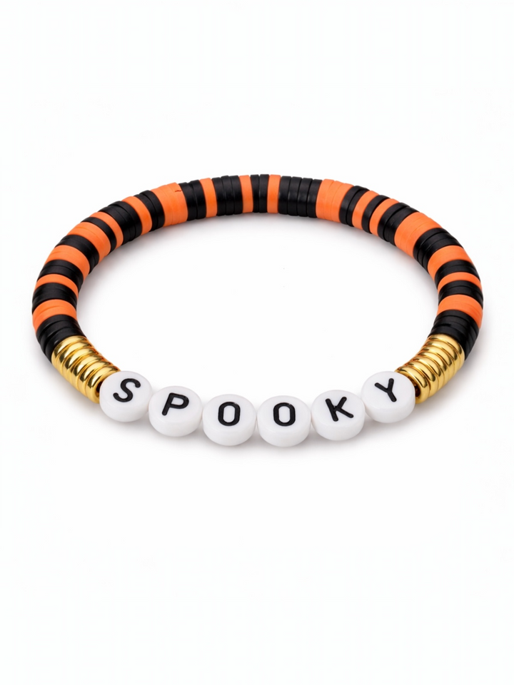 Black and orange striped bracelet with white beads spelling "SPOOKY" and gold accents. Perfect for Halloween.