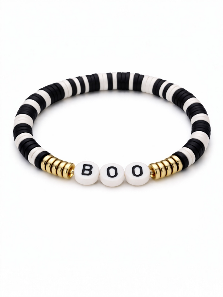 Black and white striped bracelet with gold accents featuring the beads that spell "BOO."