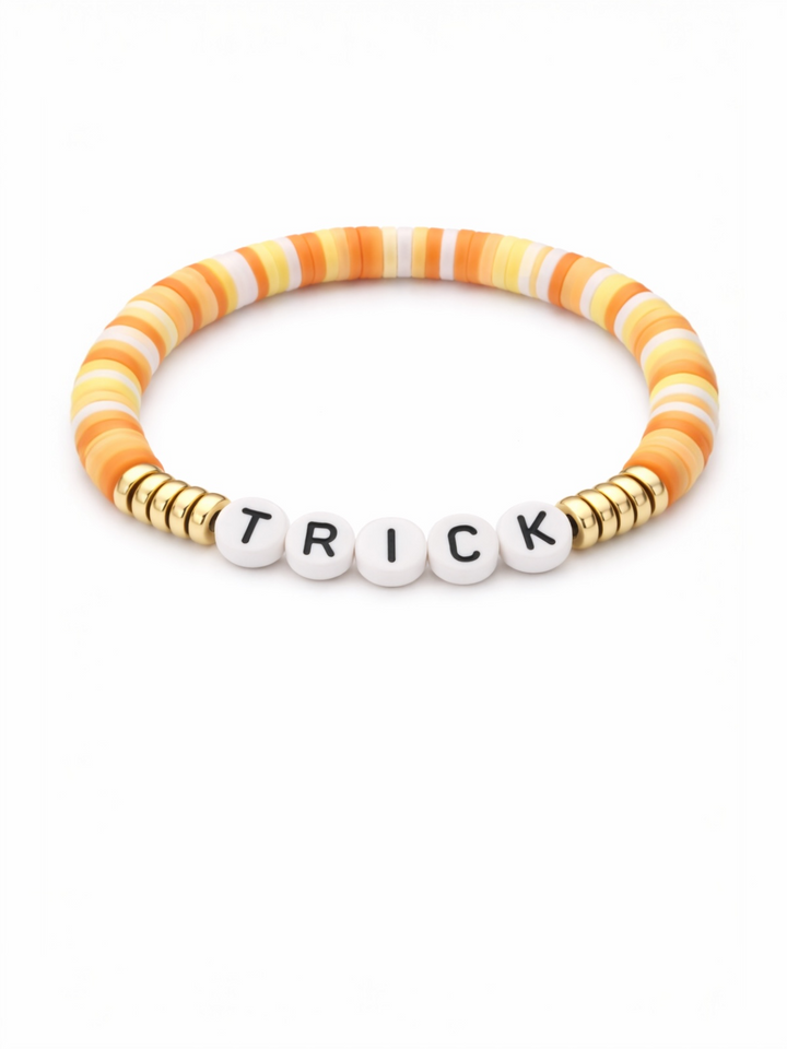 Colorful beaded bracelet with the word "TRICK" in white letters and gold accent beads.