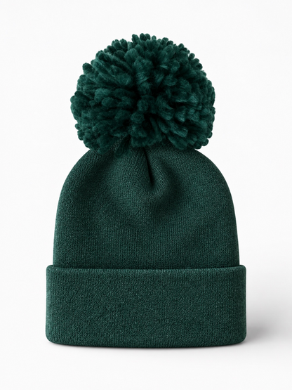 Green knit beanie with a large pom-pom on top and a folded cuff.