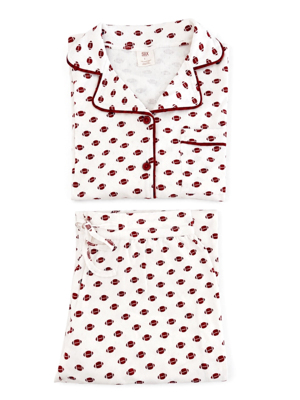 White pajama set featuring a football print, including a button-up top and drawstring pants.