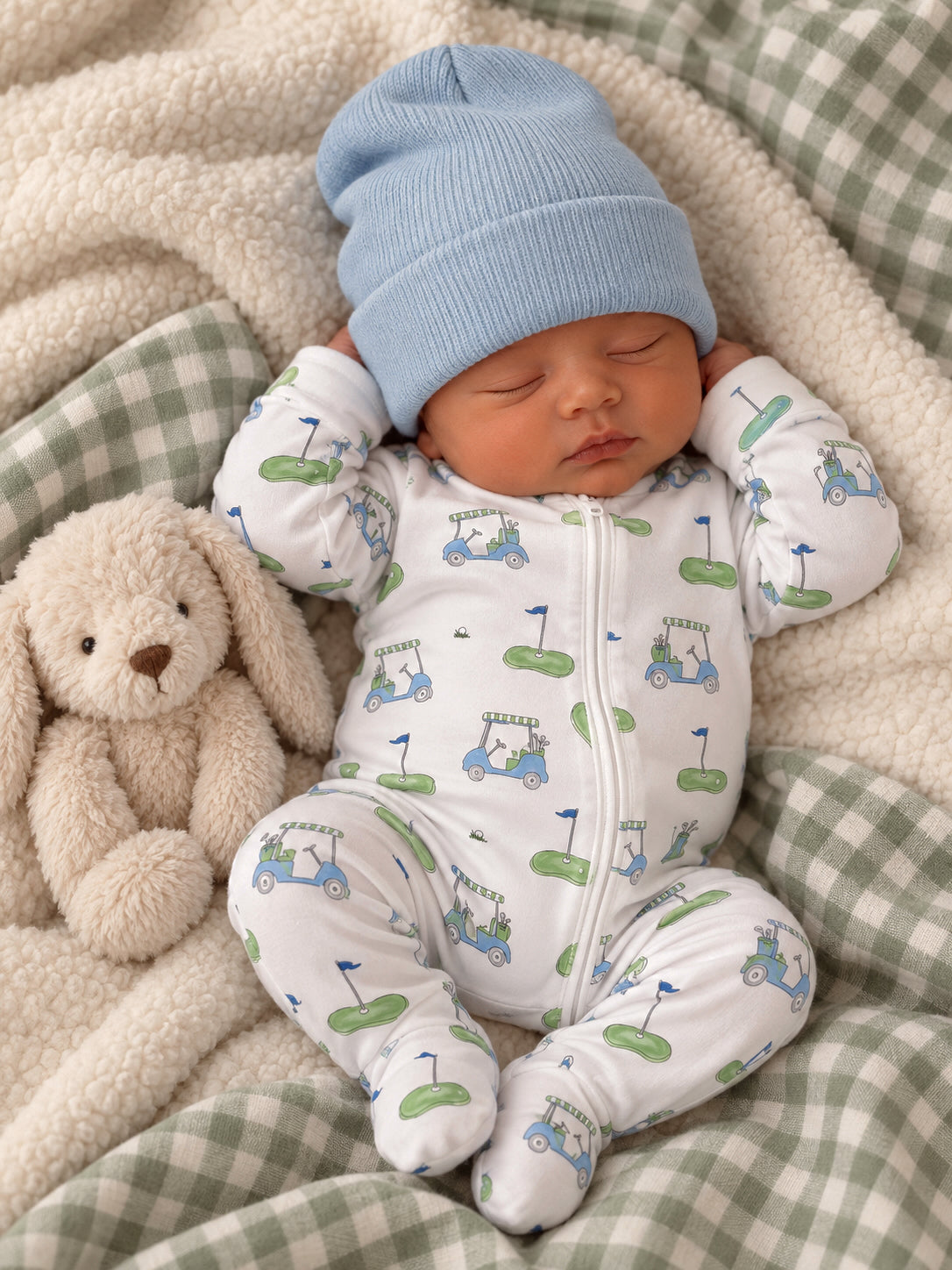 Baby peacefully sleeping in a cozy onesie with golf designs, cuddling a soft bunny on a plush blanket.
