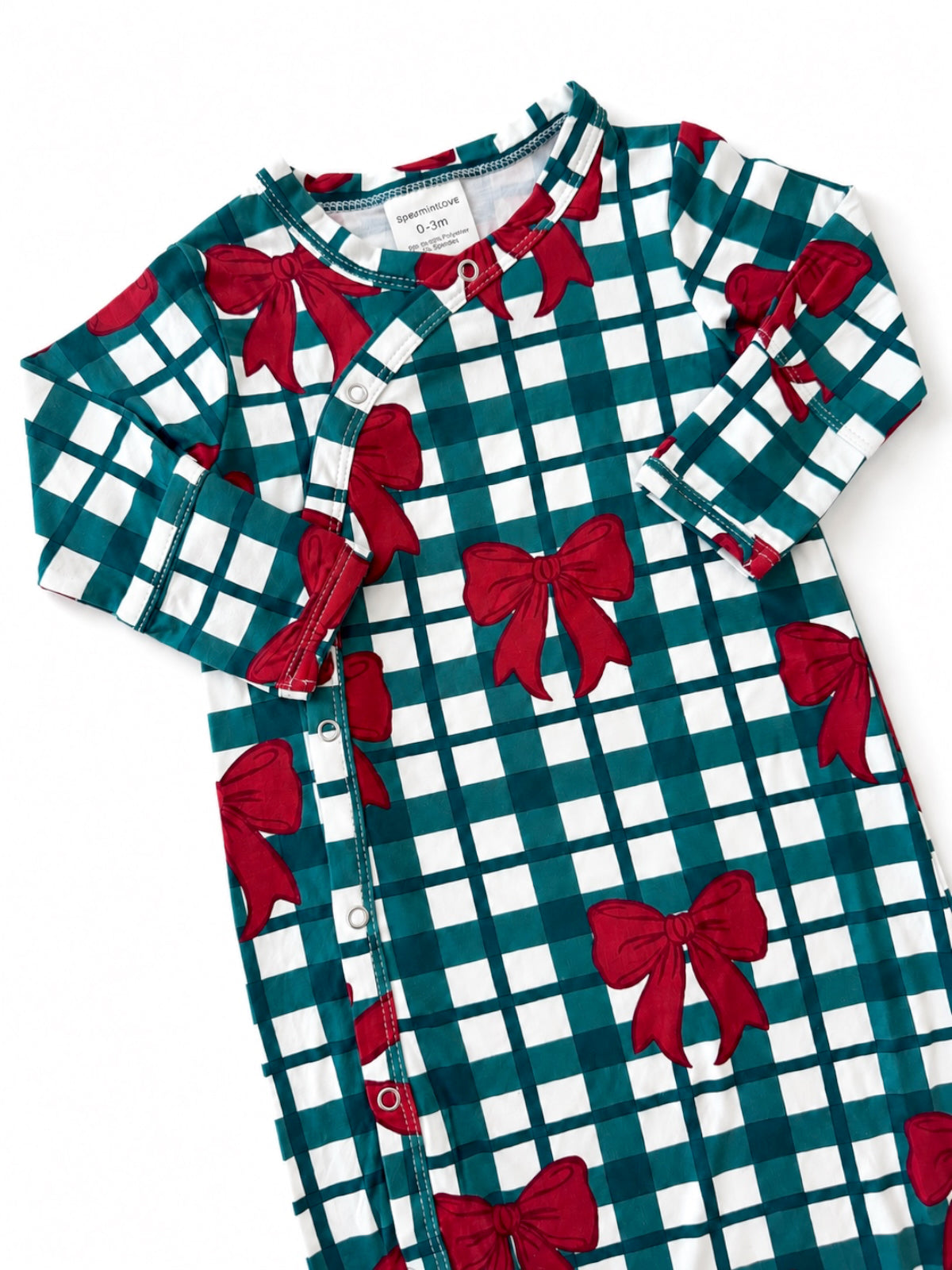 Green and white grid-patterned infant gown with red bows and snap closure.
