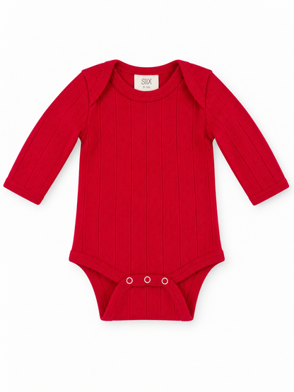 Red long-sleeve baby bodysuit with ribbed texture and snap closure at the bottom. Suitable for ages 0-3 months.