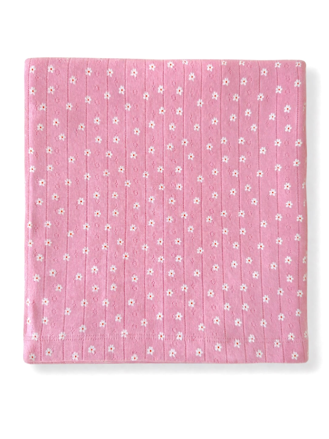 Pink fabric featuring small white flowers in a repeating pattern, textured with vertical lines.