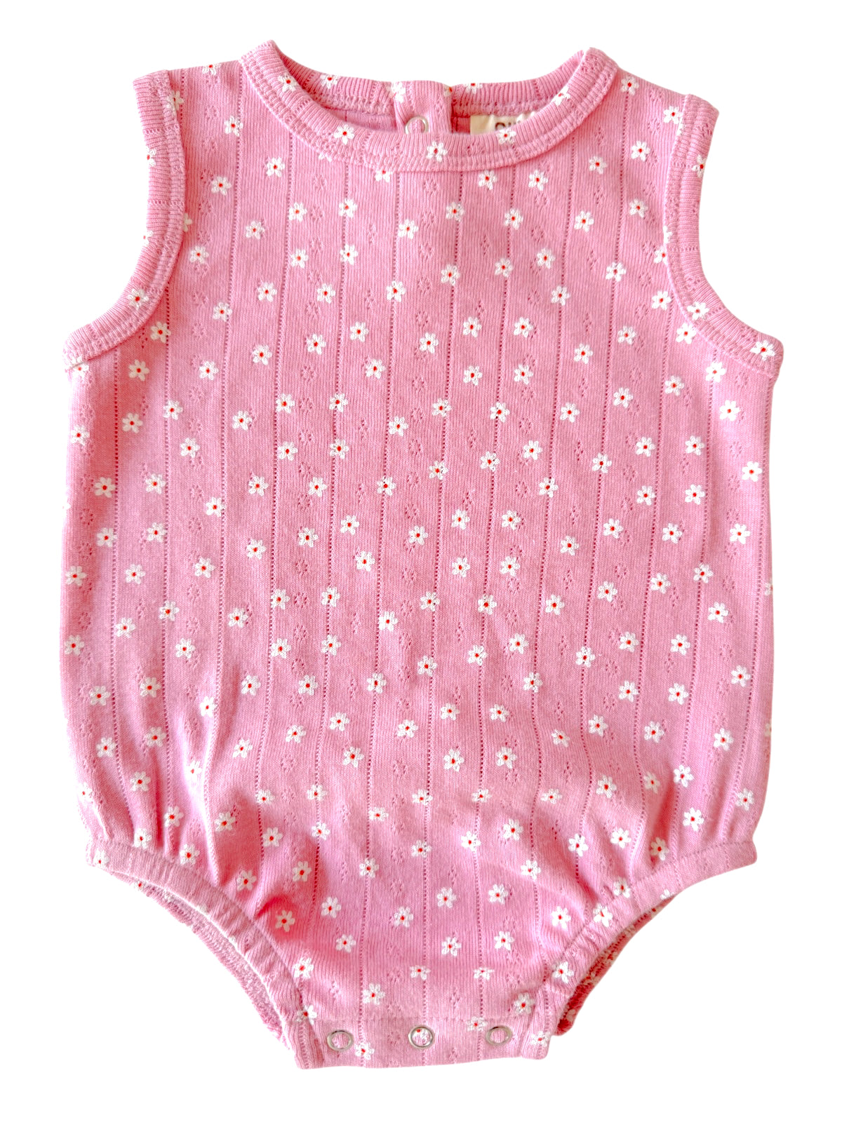 Pink sleeveless baby onesie with white floral pattern and snap closures at the bottom.
