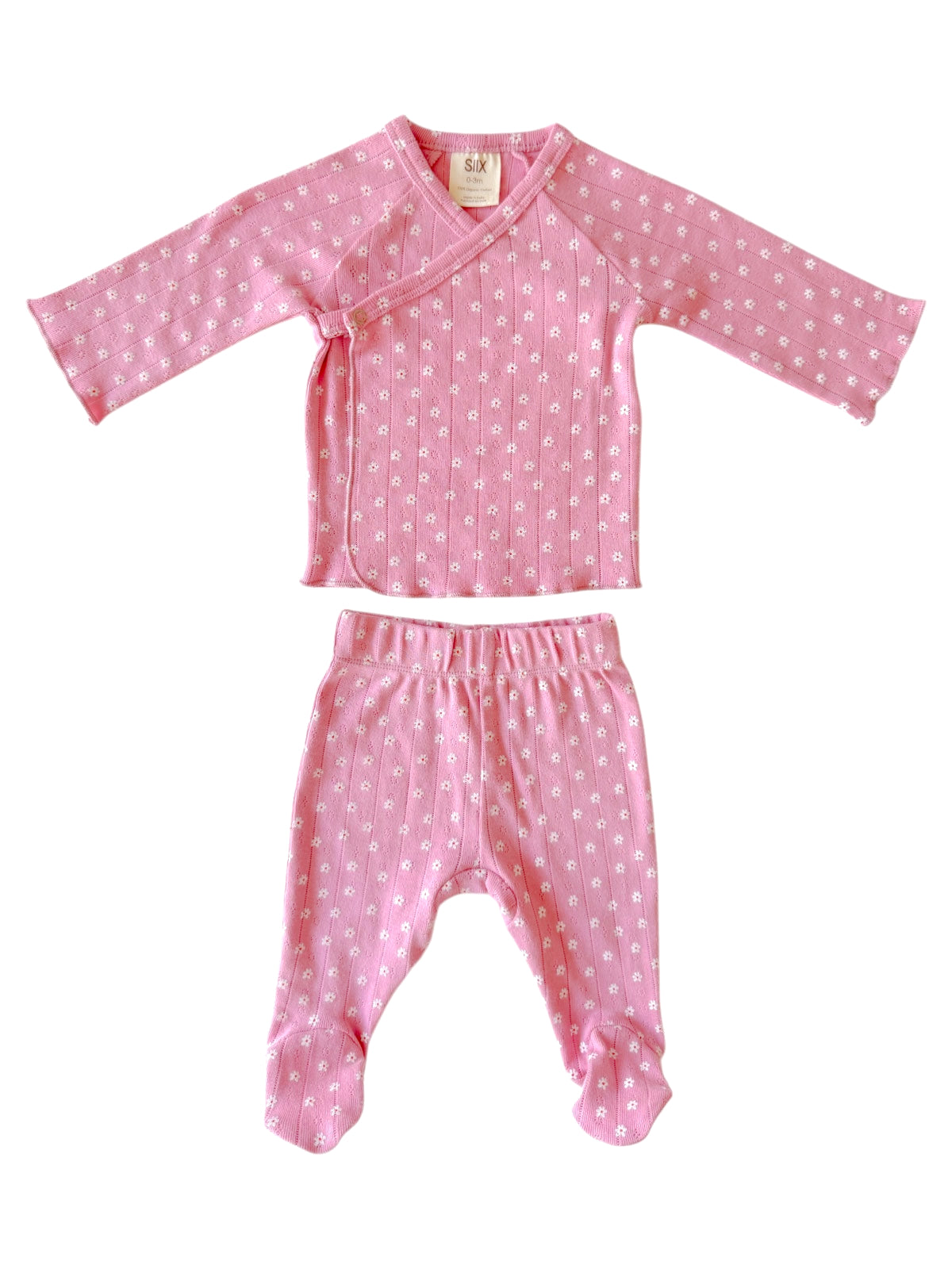 Pink baby outfit with long-sleeve top and matching pants featuring white floral patterns.