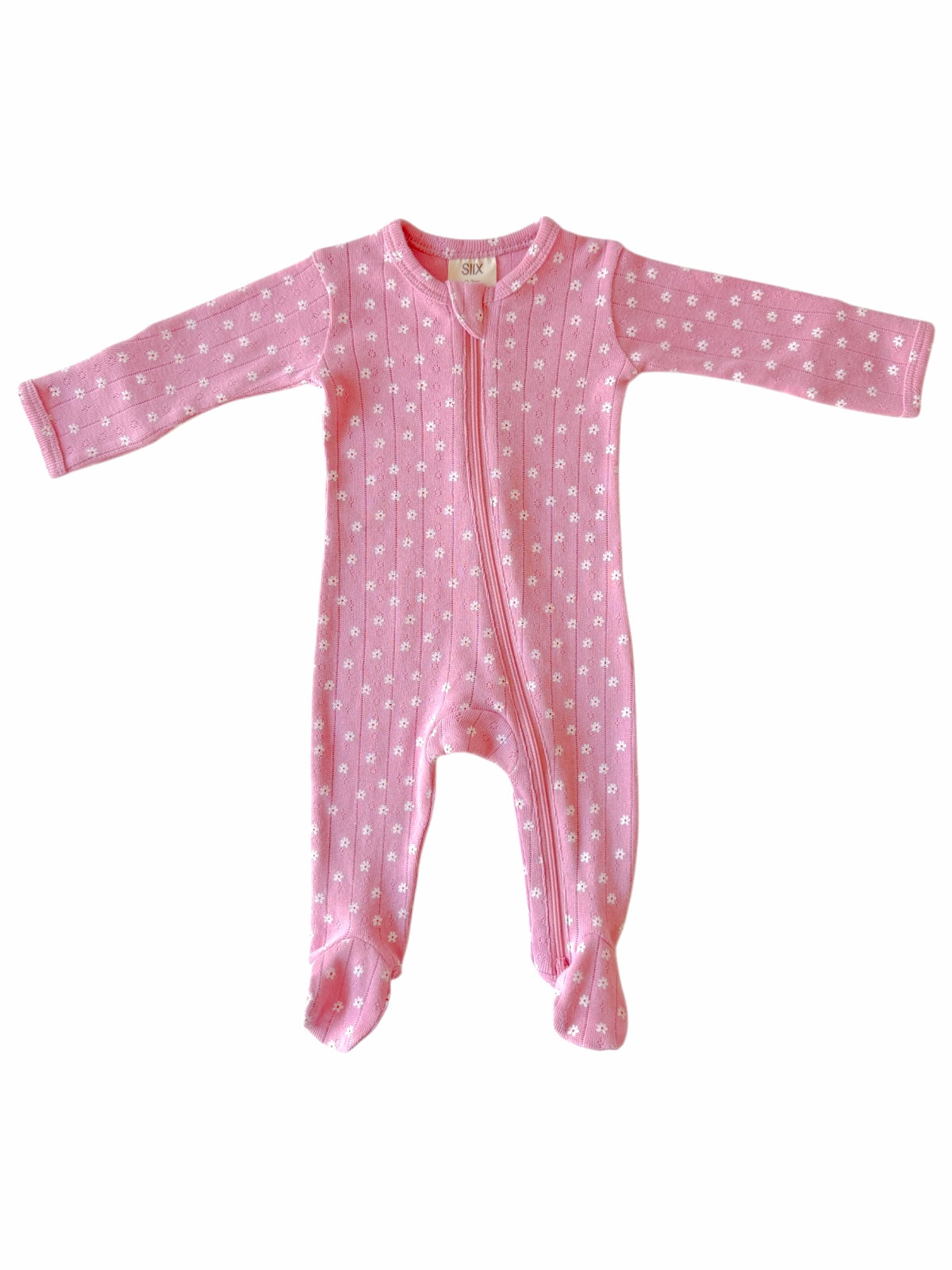 Pink baby onesie with long sleeves and a front zipper, decorated with small white flowers.