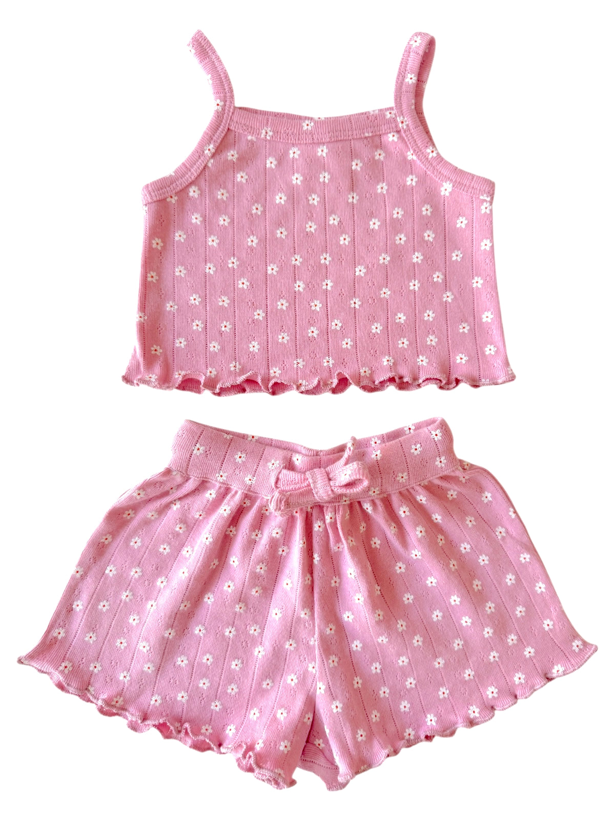 Pink floral two-piece outfit featuring a tank top and matching shorts with a bow. Perfect for warm weather.