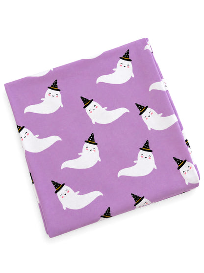 Purple fabric featuring cute white ghosts wearing black hats, scattered across the material.