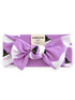 Purple headband with ghost and witch hat pattern, featuring a large bow and soft fabric. Brand label included.