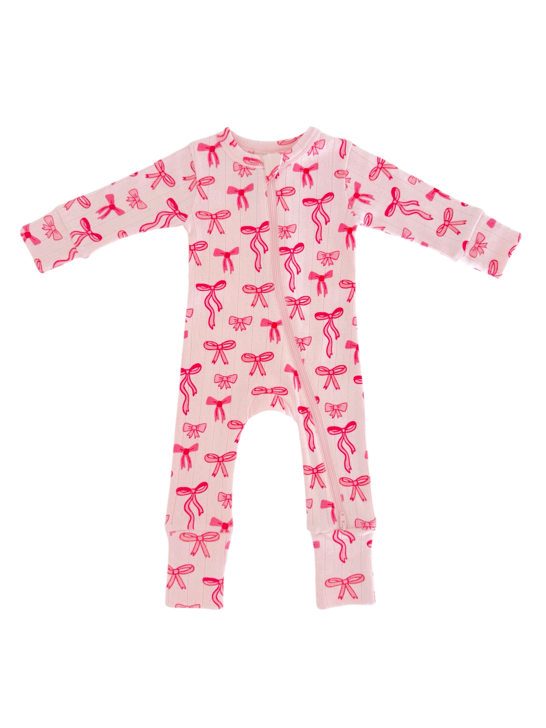 Pink infant onesie with red bow patterns, featuring long sleeves and a front zipper.