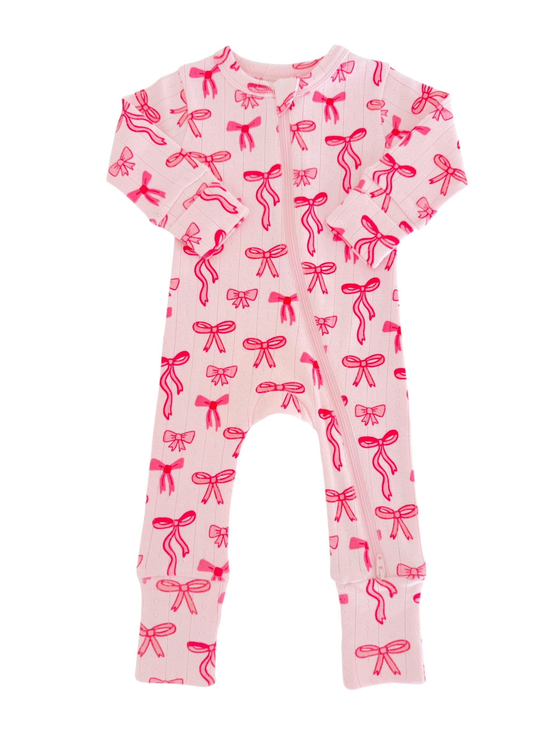 Pink baby onesie with red bows, featuring long sleeves and a front zipper closure. Ideal for comfort and style.