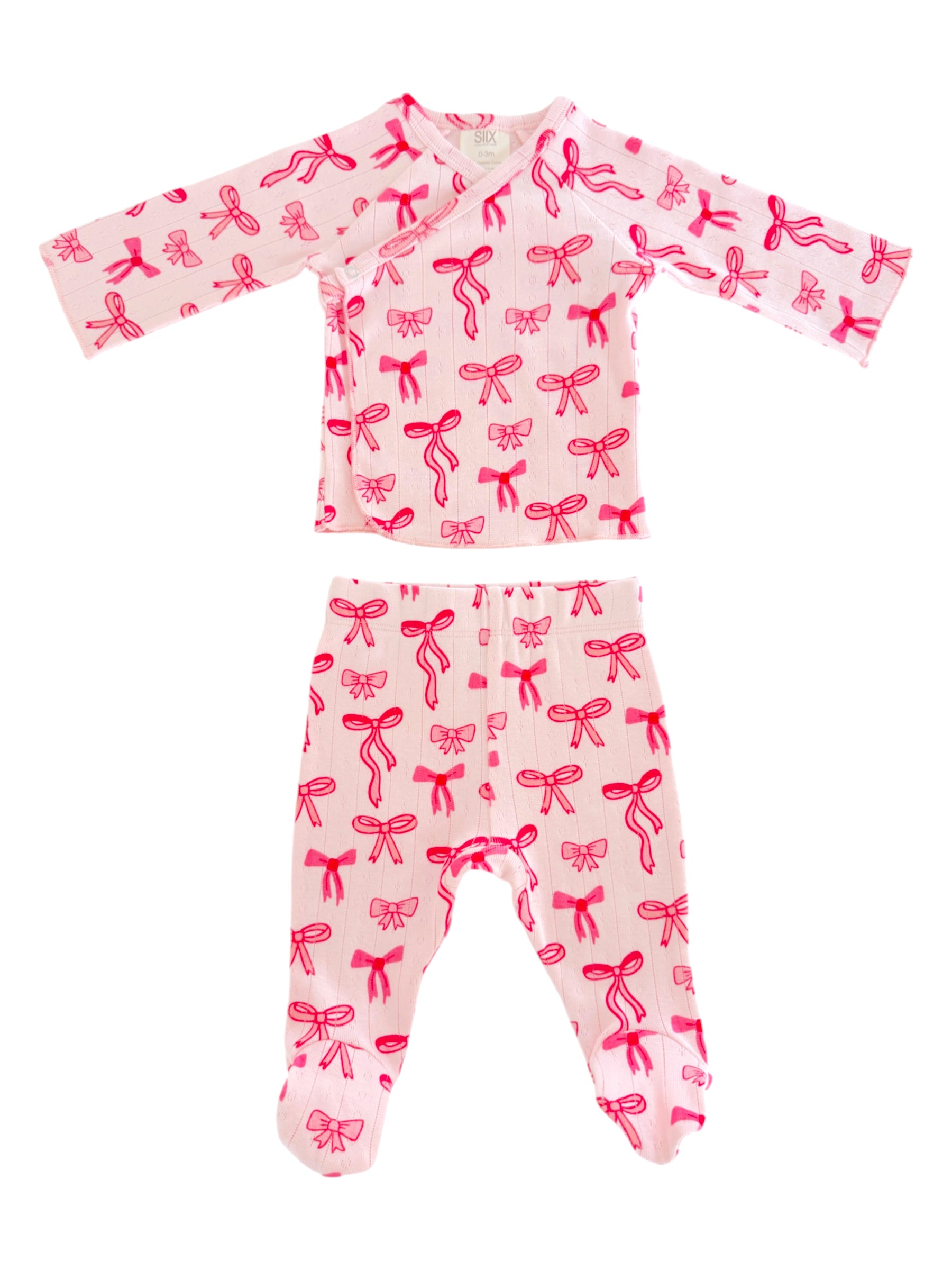Pink baby outfit with long sleeves and footed pants, featuring a pattern of bright pink bows.