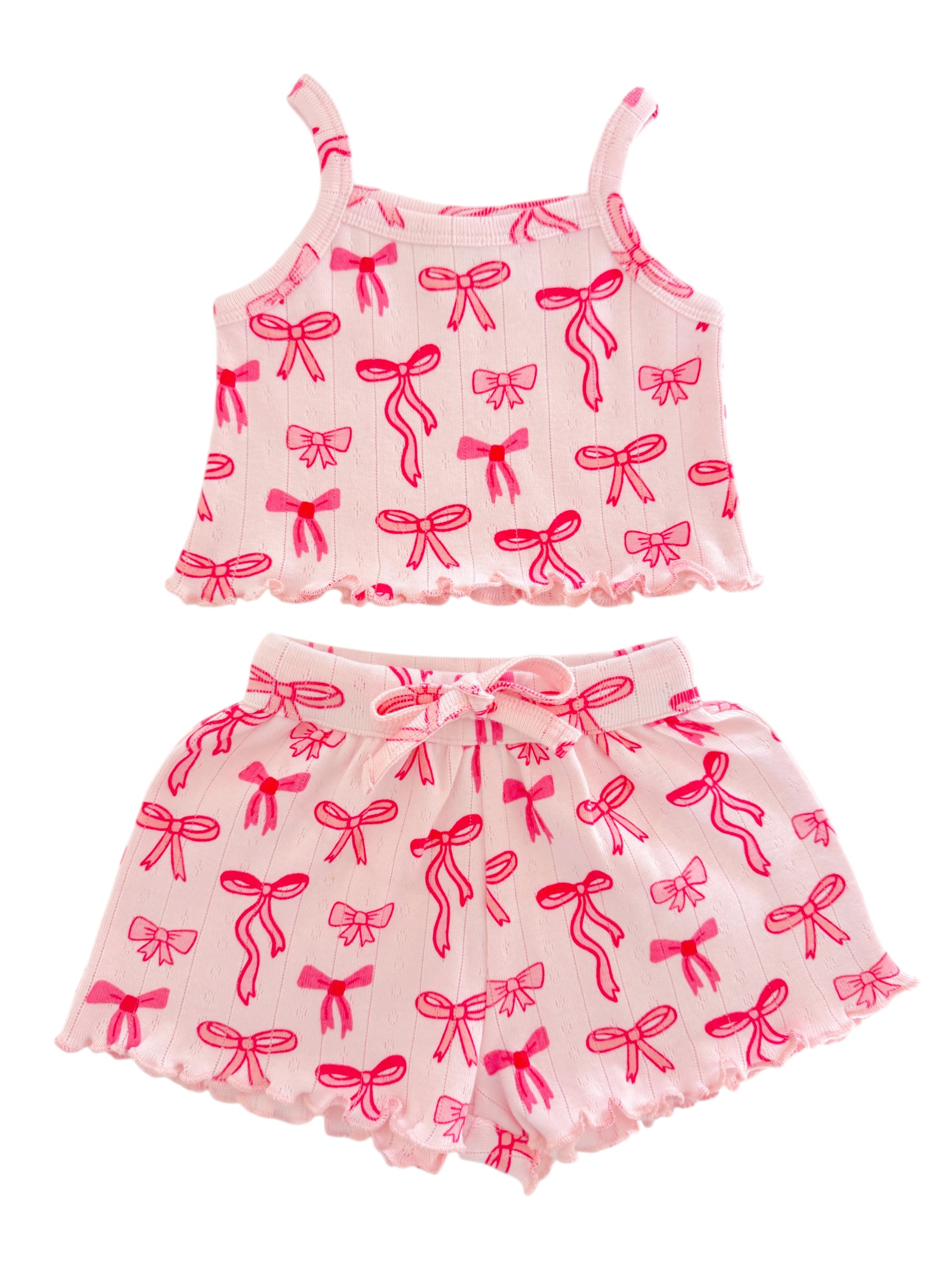 Pink pajama set featuring a sleeveless top and shorts, decorated with bright pink bow patterns.