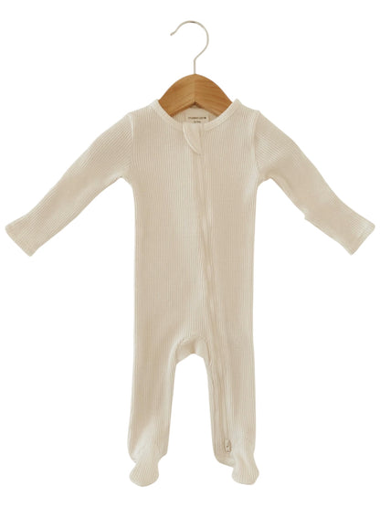 White ribbed baby onesie hanging on a wooden hanger.