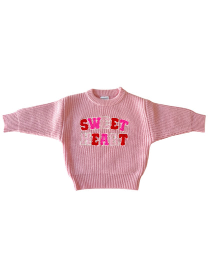Pink sweater with "SWEET HEART" embroidered in colorful text across the front. Stylish, relaxed fit design.