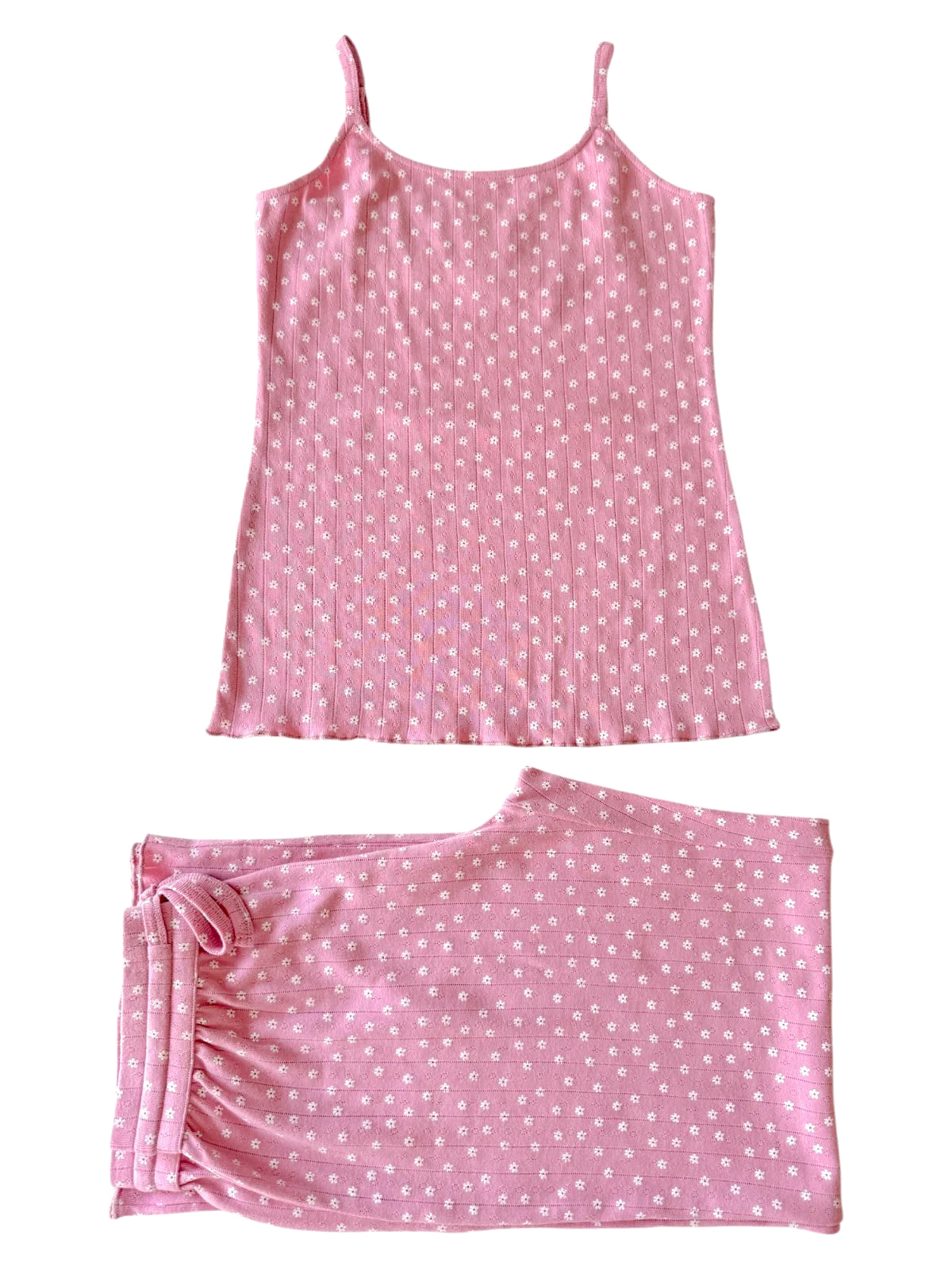 Pink floral sleepwear set featuring a cami top and matching shorts. Ideal for comfort and style at home.