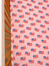 Pink crib sheet featuring a repeated pattern of small American flags.