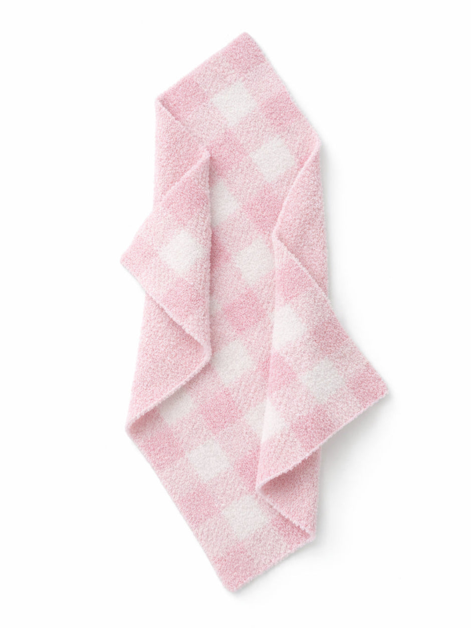 Pink checkered towel folded on a white background, featuring a soft, plush texture.
