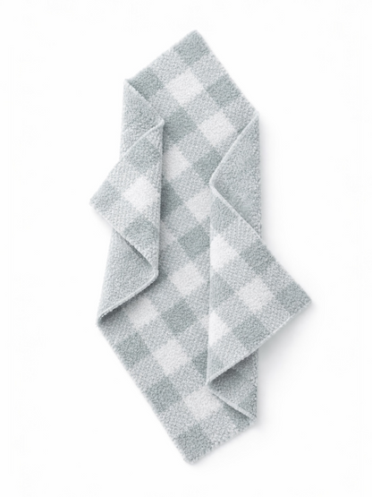 Gray and white checked dish towel folded on a white background. Ideal for kitchen use and decor.