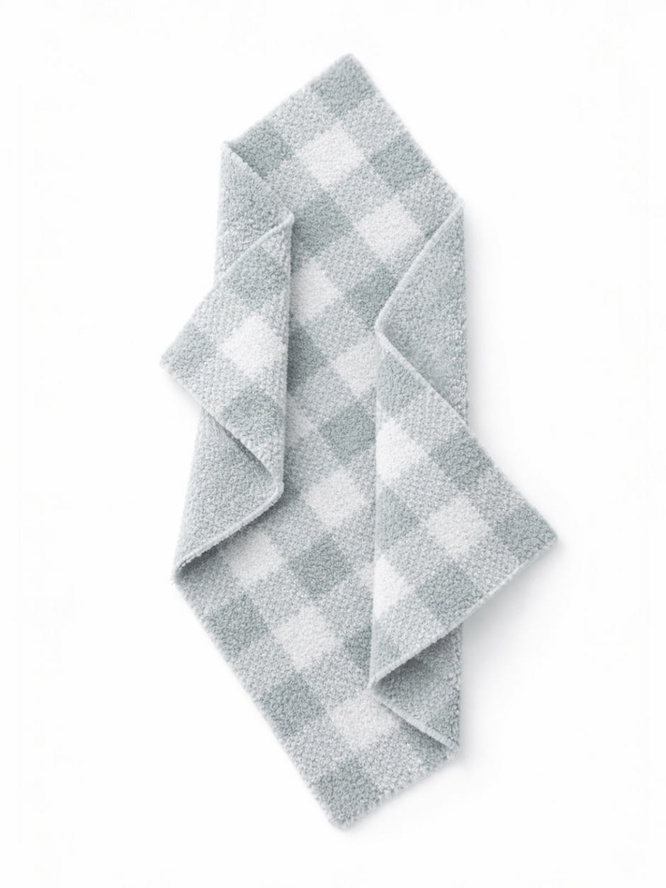 Gray and white checked dish towel folded on a white background. Ideal for kitchen use and decor.