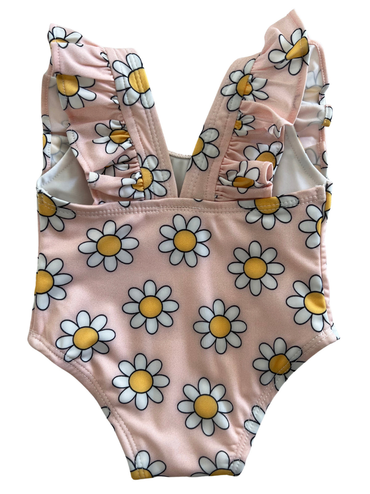 Pink swimsuit with white daisies and yellow centers, featuring ruffled straps and a one-piece design.