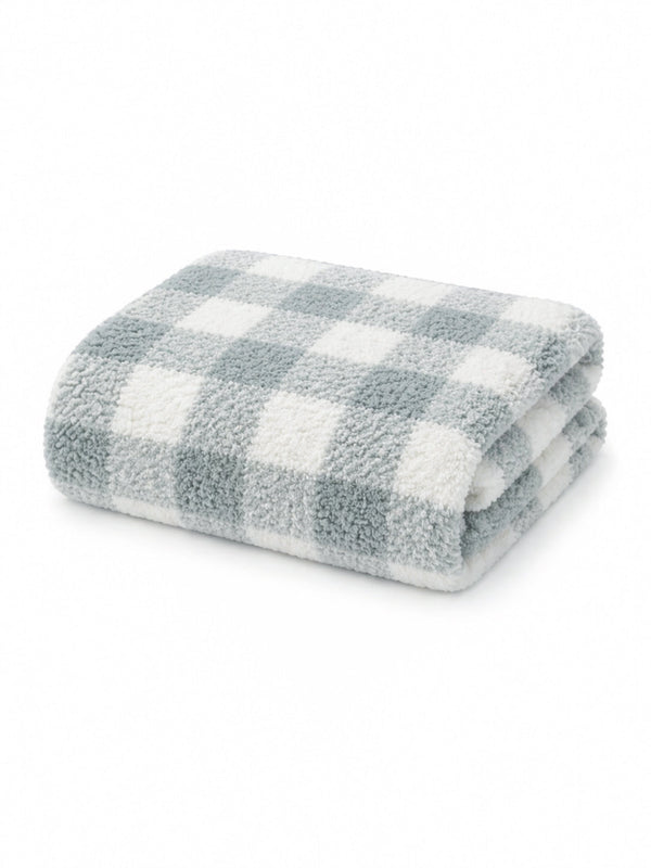 Soft, folded blanket with a blue and white checkered pattern on a white background.