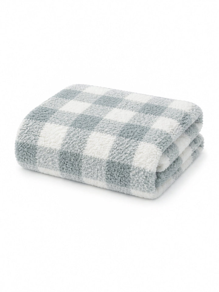 Soft, folded blanket with a blue and white checkered pattern on a white background.