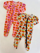 Two playful pumpkin-themed toddler pajamas in pink and white. Perfect for cozy fall nights.