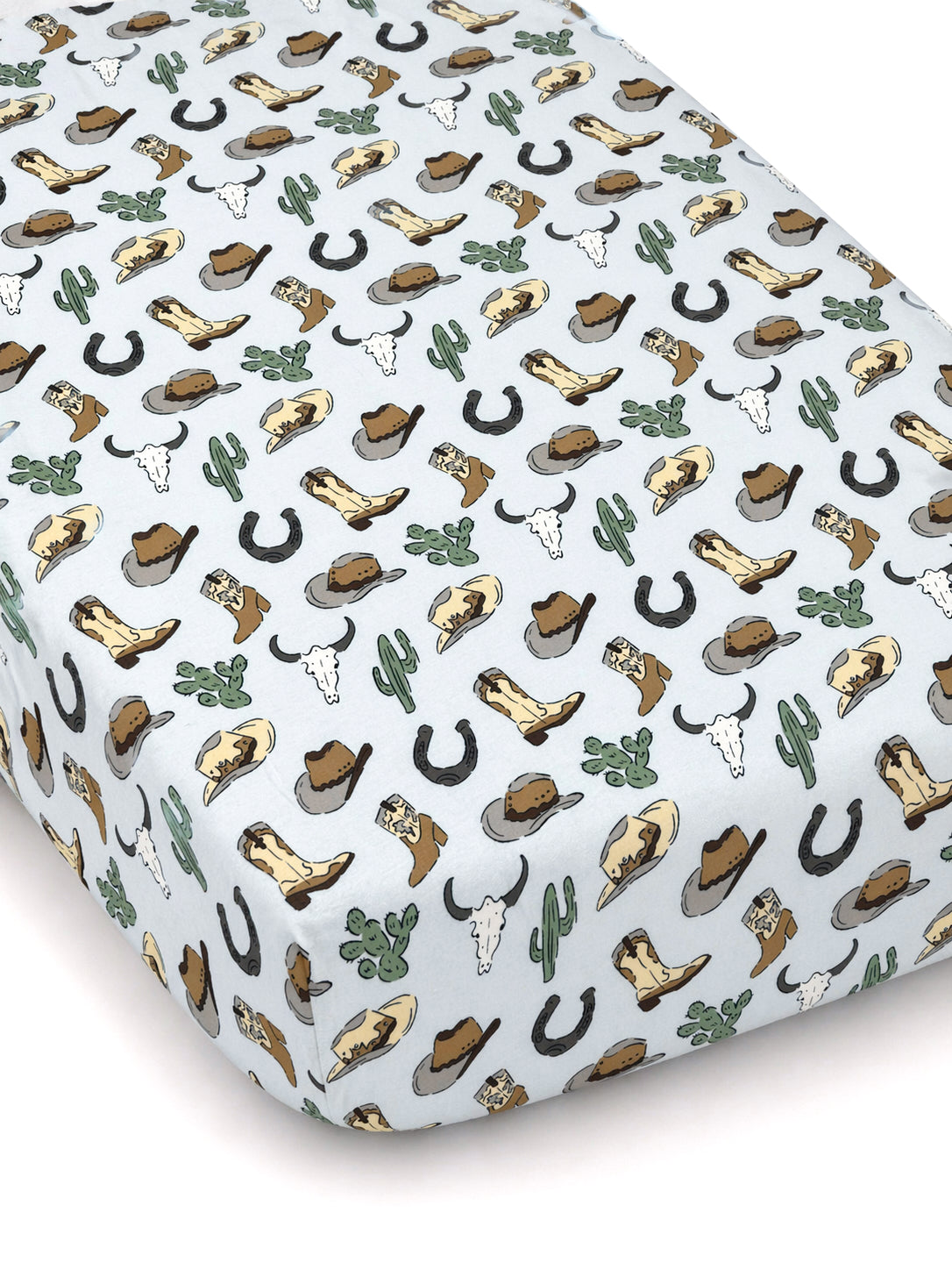 Light blue crib sheet featuring a western pattern of boots, hats, cacti, horseshoes, and cow skulls.