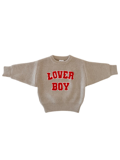 Beige sweater with red "LOVER BOY" text, featuring a loose fit and ribbed cuffs. Perfect casual fashion piece.