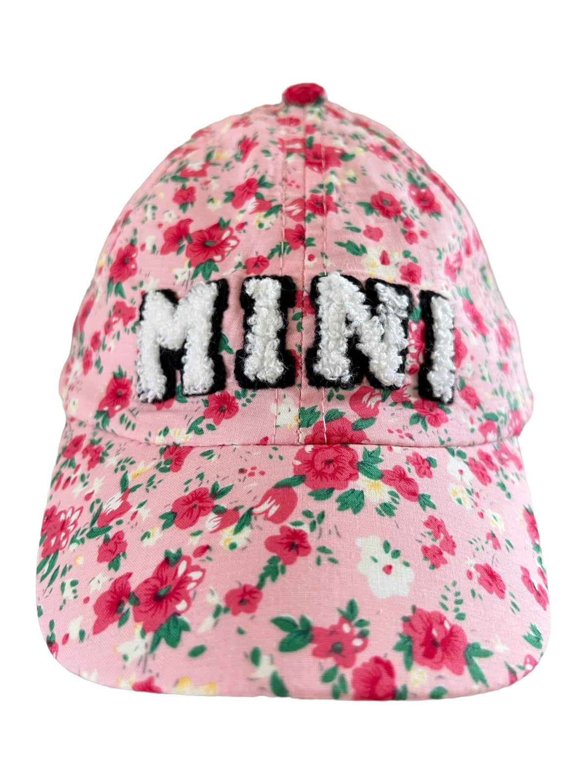 Pink floral cap with "MINI" embroidered in fluffy white and black letters on the front.