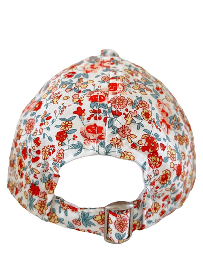 Floral-patterned cap viewed from the back, featuring a strap and metal buckle.