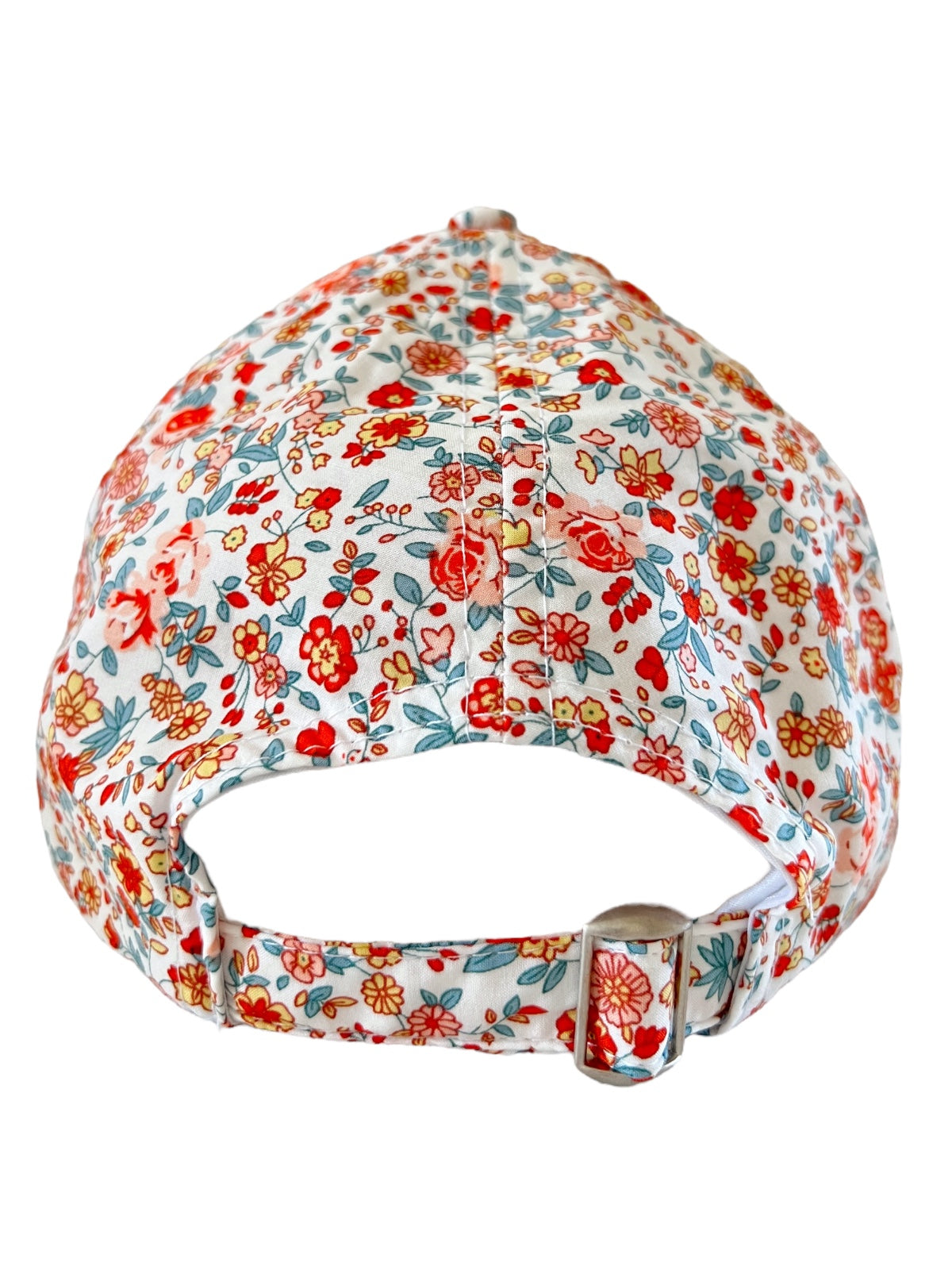 White floral cap featuring red and blue flowers, adjustable strap at the back.