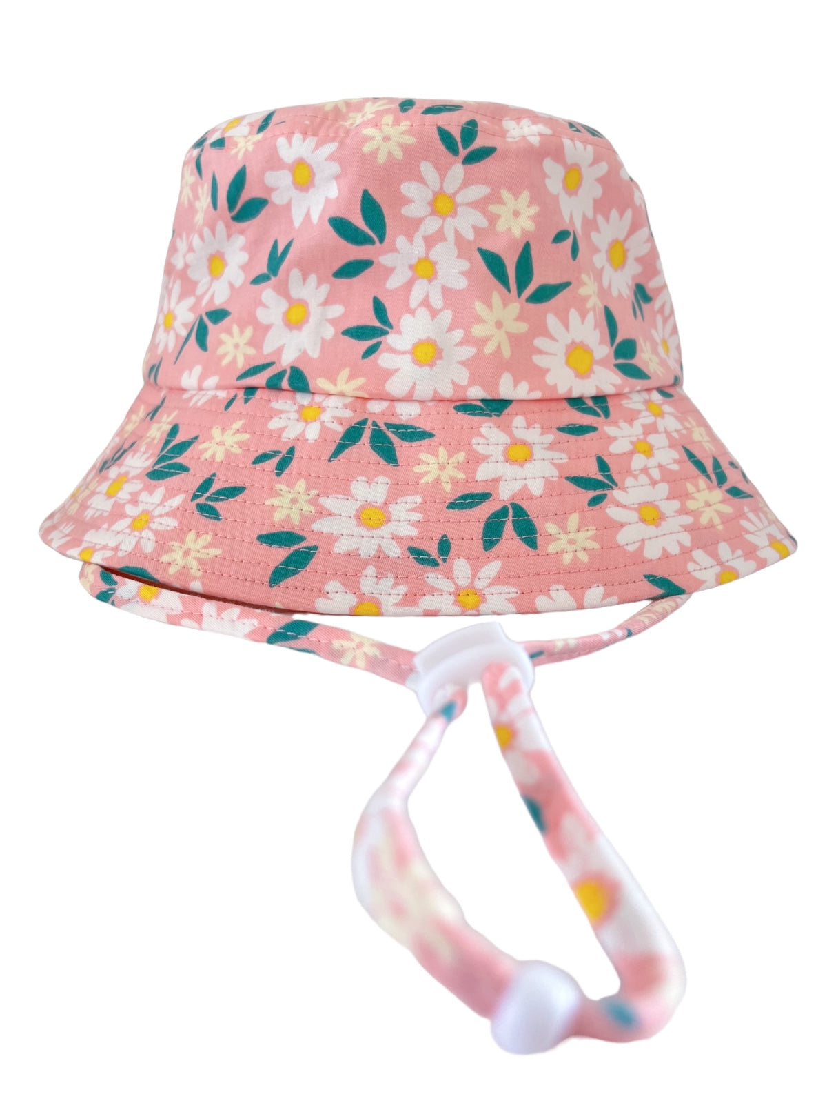 Pink floral bucket hat with a chin strap, featuring white daisies and green leaves against a soft pink background.