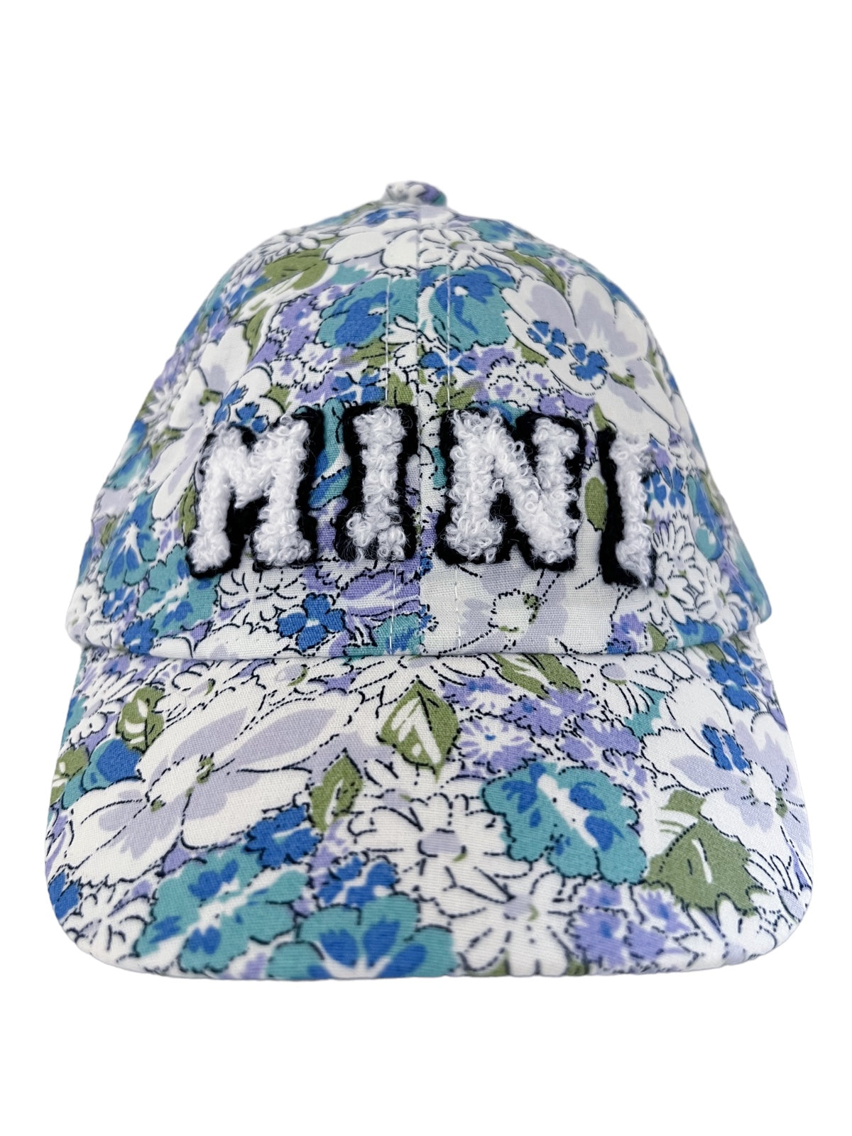 Floral cap featuring the word "MINI" in textured black lettering on the front panel.