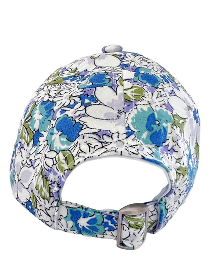 Back view of a colorful floral cap featuring blue, green, and white patterns with an adjustable strap.