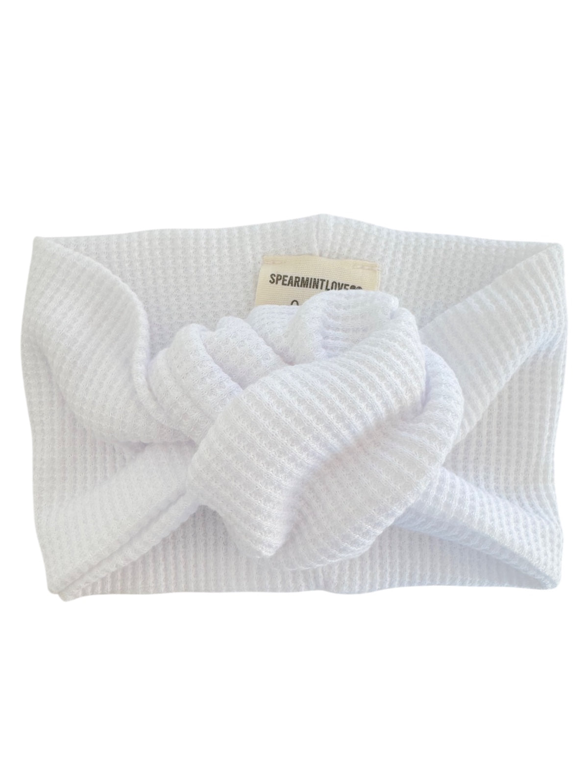 White textured headband with a knot detail, perfect for hair styling or keeping hair away from the face.