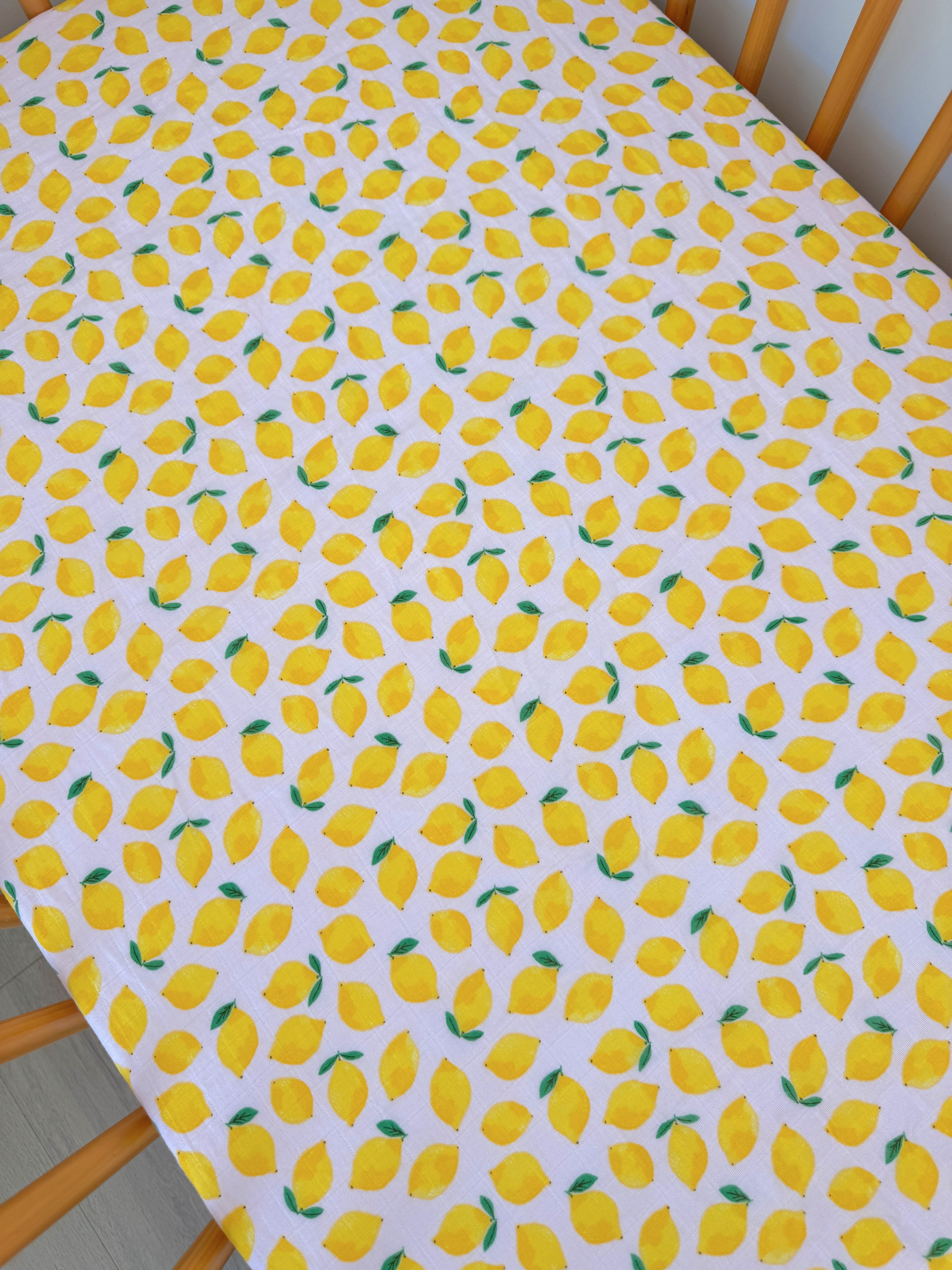 Tablecloth with a yellow lemon pattern on a white background. Bright and cheerful design for home decor.