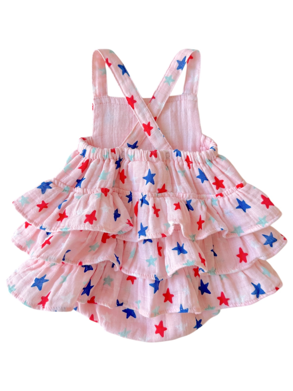 Pink dress with ruffled skirt, decorated with red, blue, and turquoise stars. Adjustable shoulder straps.