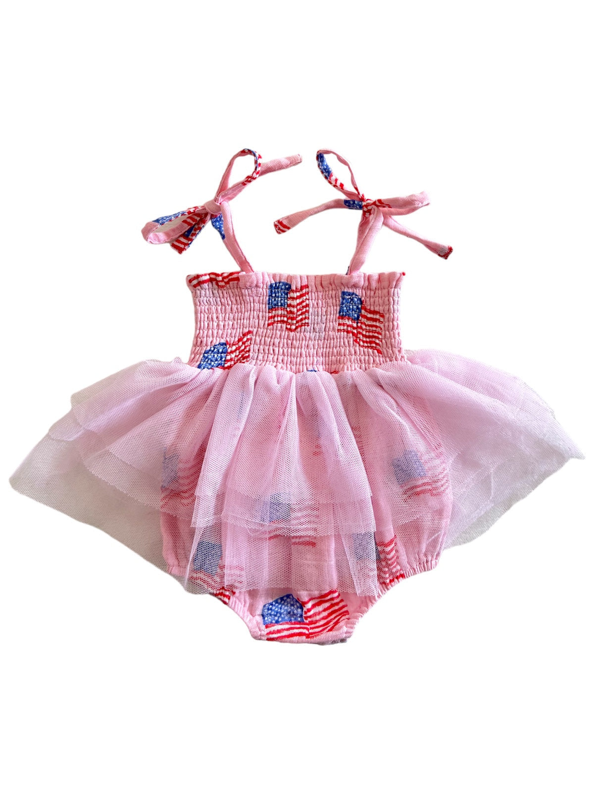 Pink dress with American flag print, featuring a smocked bodice and tulle skirt, ideal for festive occasions.