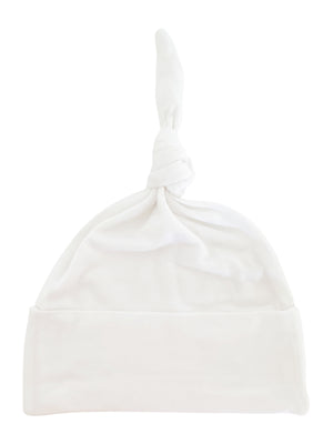 White baby hat with a knotted top and folded cuff, made of soft fabric.