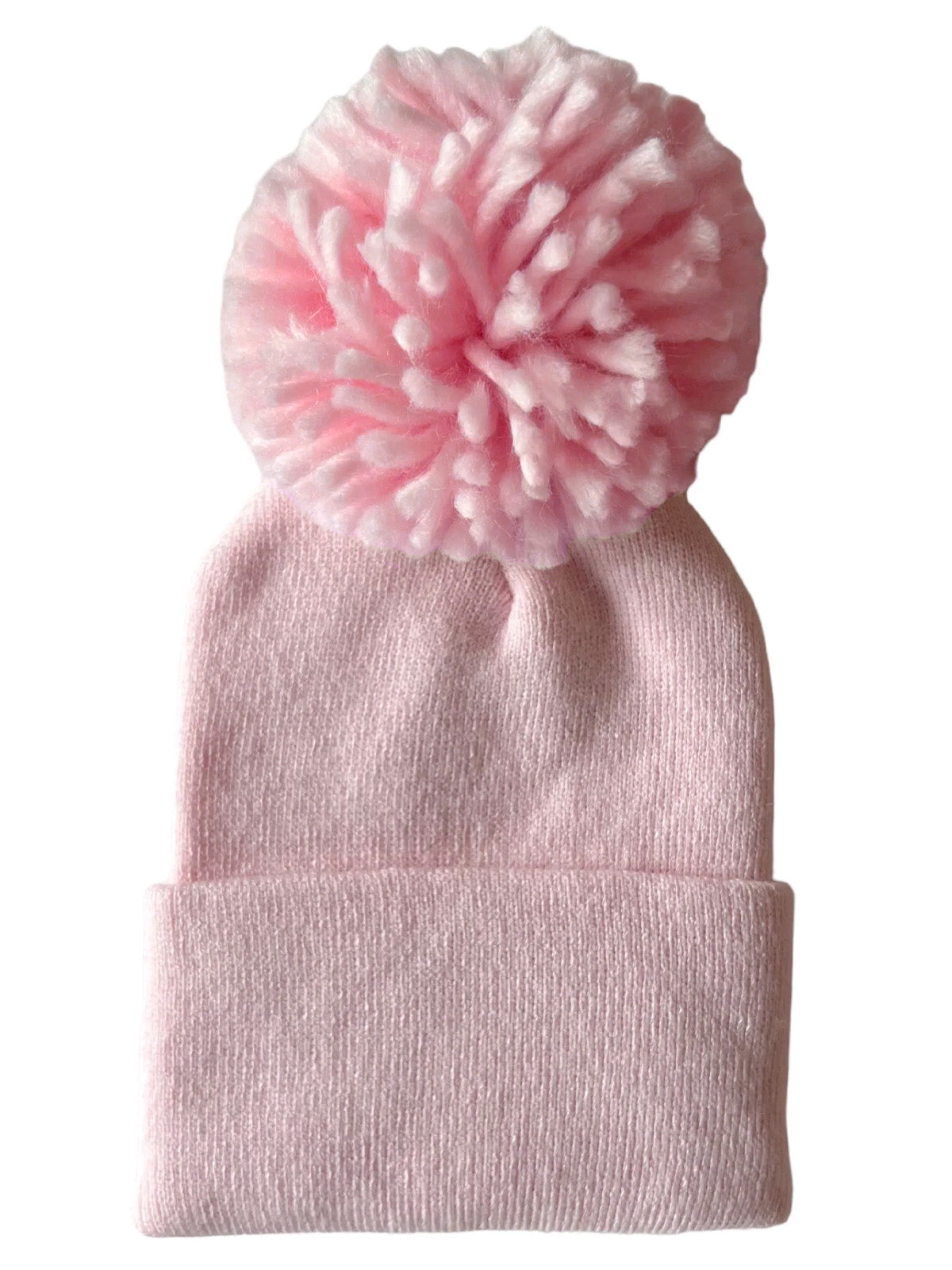 Pink knitted beanie hat with a large fluffy pom-pom on top, ideal for winter wear.