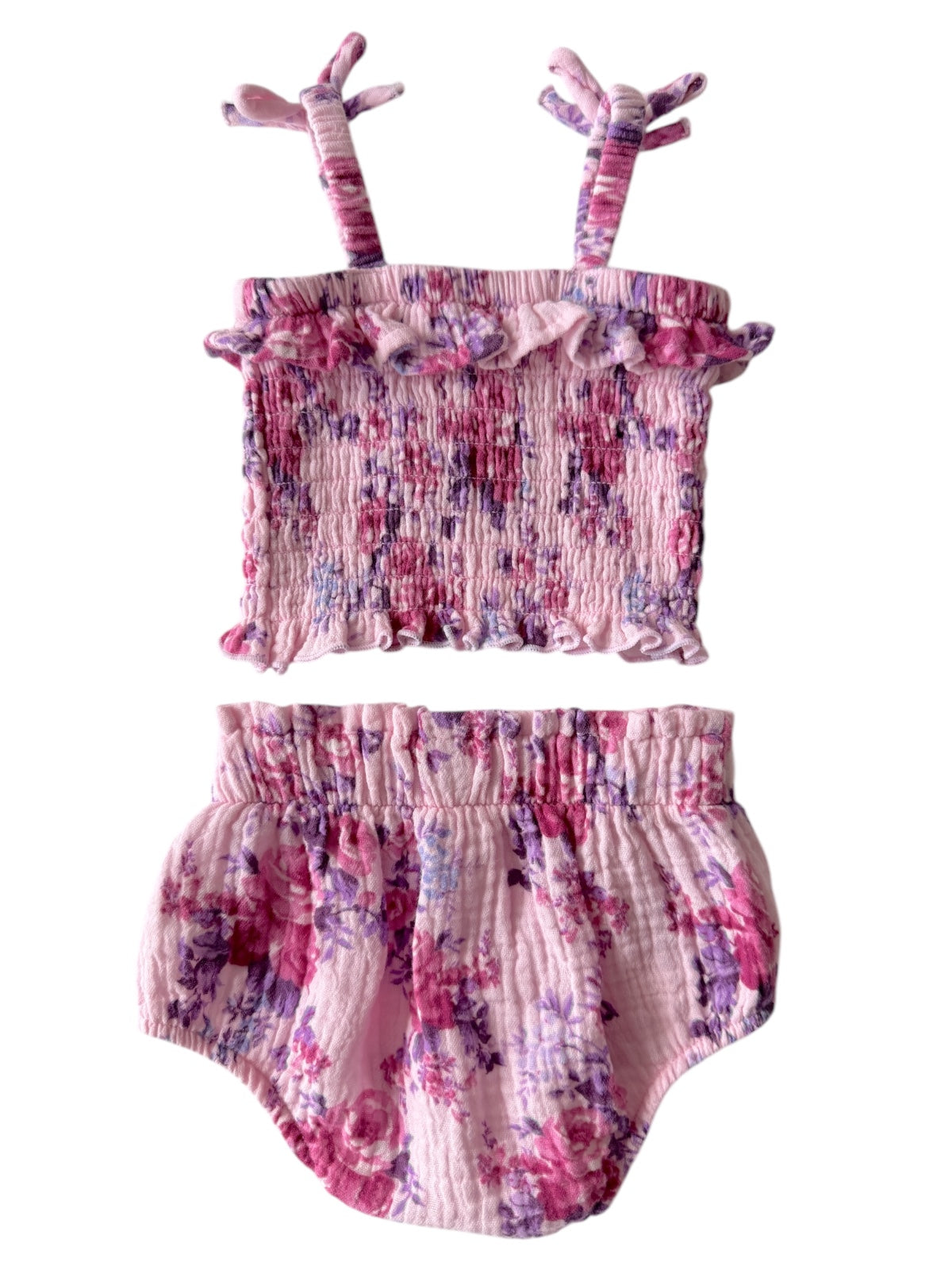 Pink floral baby outfit featuring a ruffled top with tie straps and matching bloomers, ideal for warm weather.
