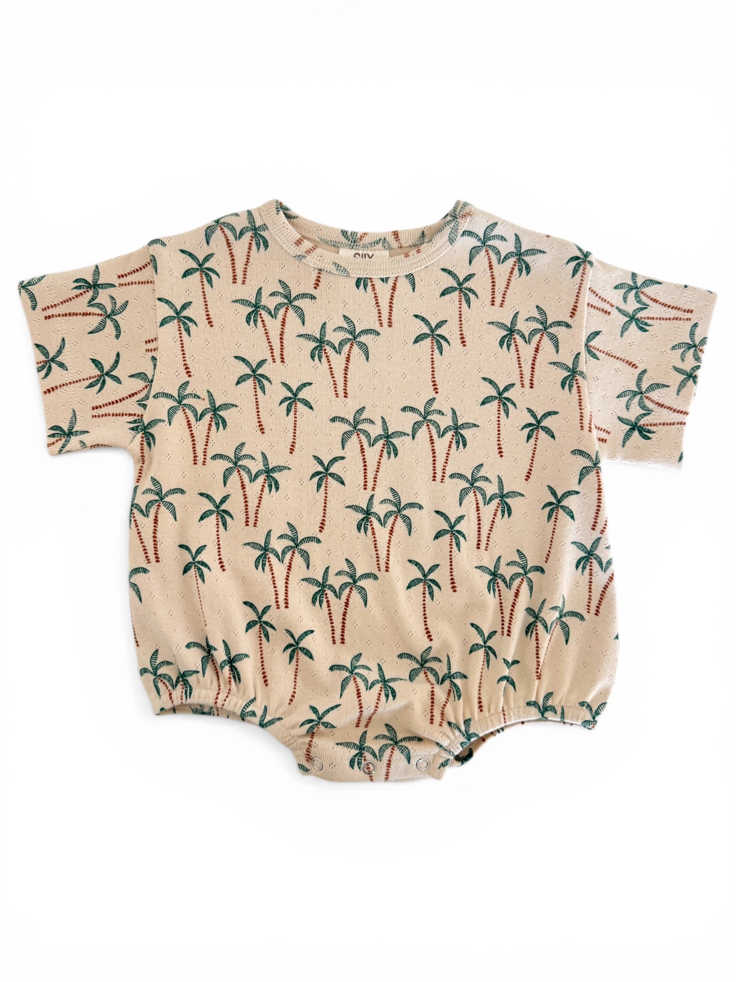 Beige romper with a palm tree print, featuring short sleeves and elasticized bottom. Perfect for warm weather.