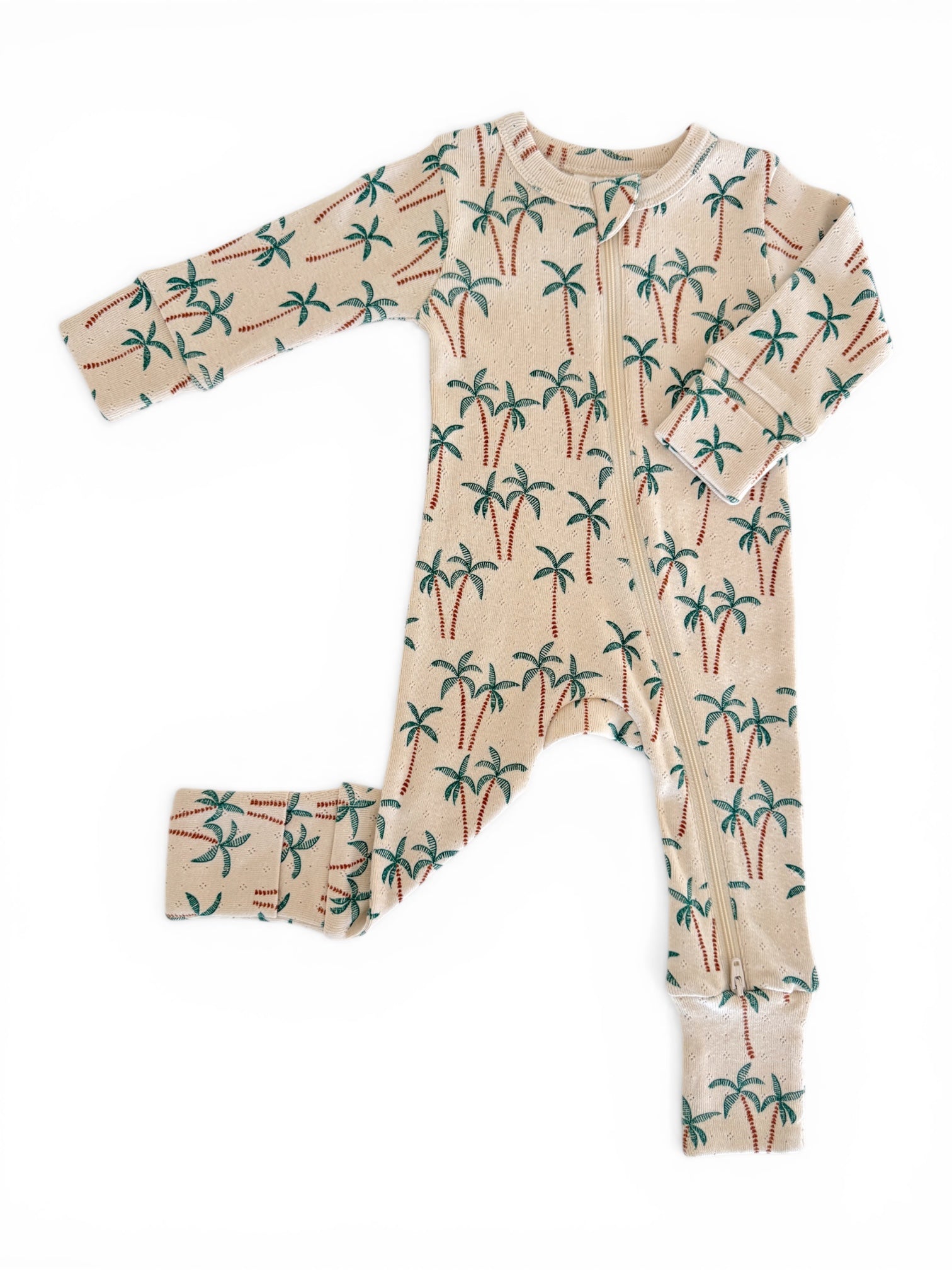 Beige infant onesie with green and brown palm tree prints, featuring a front zipper and long sleeves.